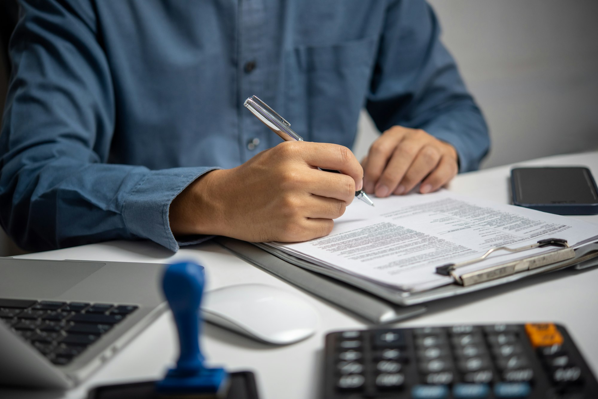 Business person Writing contract law and paper work for business and finance investments , write doc